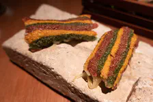 Cracker, various flavors in the stripes, onion, spinach, on top of a torch toasted goat cheese
