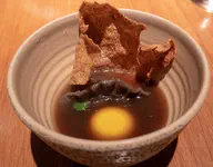 Mushroom broth, soy cured egg yolk, mushroom and miso dumpling, mushrrom cracker