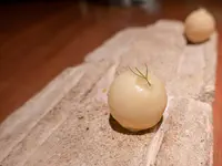 White chocolate pearls filled with mango and passionfruit puree