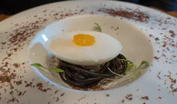 Spherified fruit juice yolk, fruit gel white, white chocolate eggshell, chocolate nest