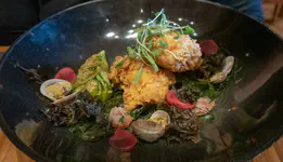 "Sweated" (steamed) fish soup but with crispy breaded fish and cockles