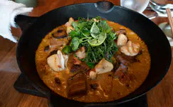 Charcoal seafood rice, shiitake dashi, yuzu kosho, bitter greens