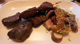 Beef heart anticuchos, confit potatos in pork fat, crispy potato skins