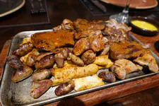 Sampler of traditionalPeruvian street grilledfood. Beef Heart, Chicken Heart, Chicken Gizzards, Chicken Skin